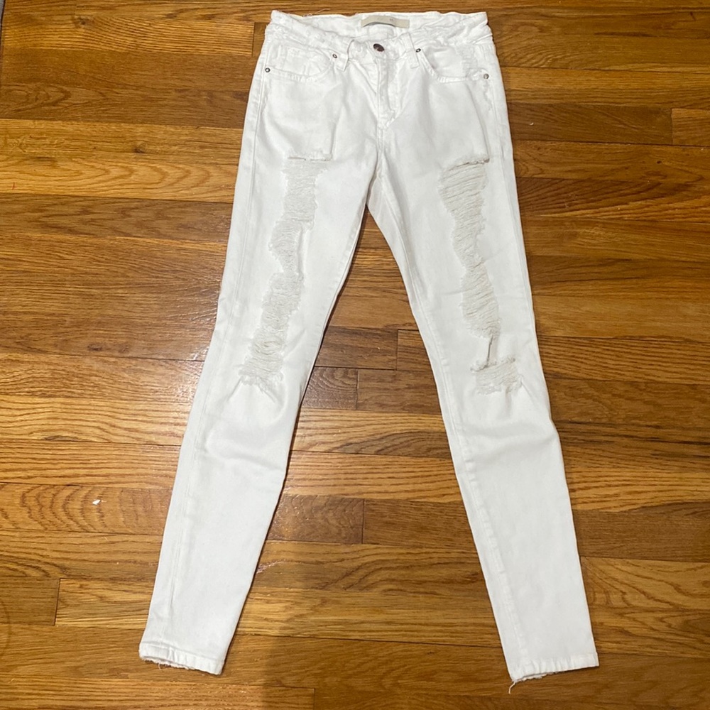 Distressed white skinny jeans